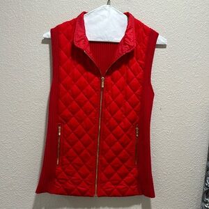 Red puffer vest, front gold zipper, pocket gold zippers.
